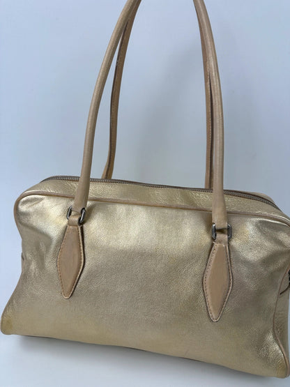 Miu Miu gold leather handbag with shiny finish and vintage 90’s design.