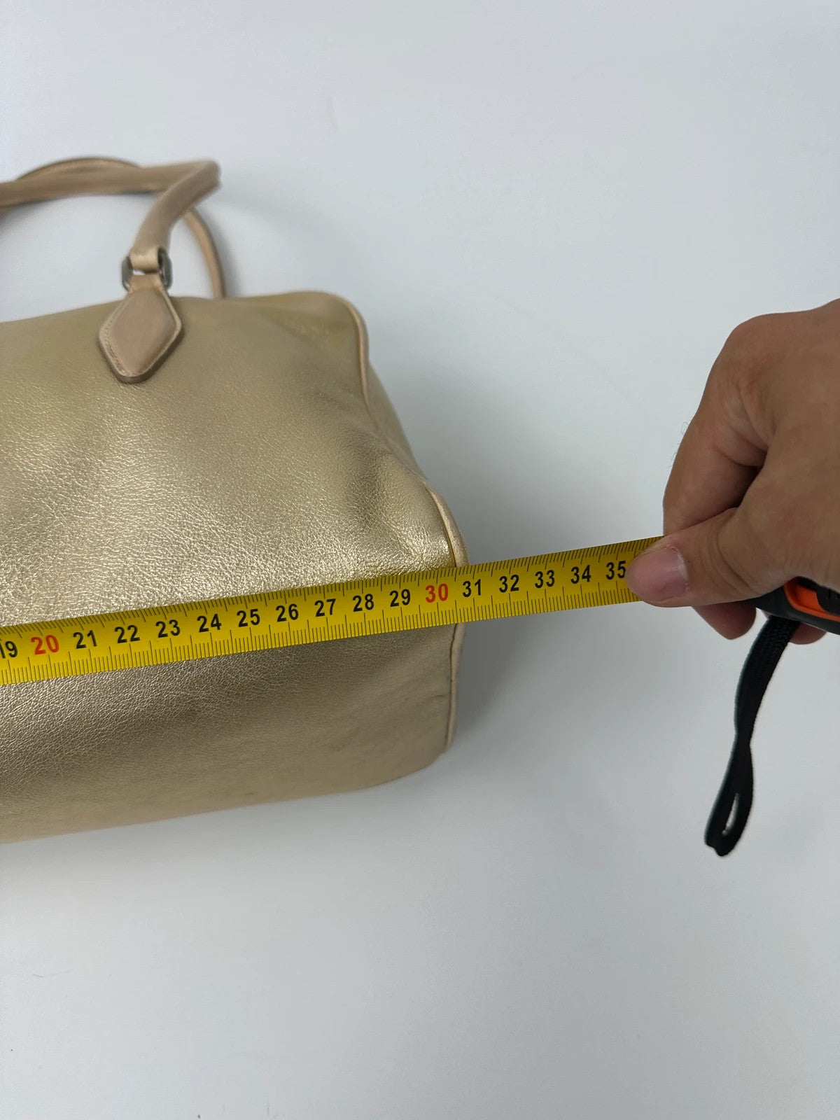 Miu Miu gold leather handbag with shiny finish and vintage 90’s design.