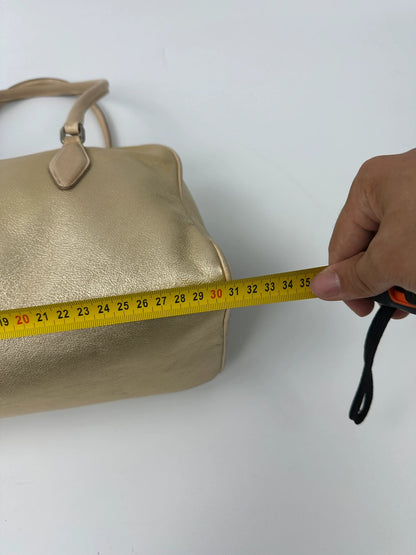 Miu Miu gold leather handbag with shiny finish and vintage 90’s design.