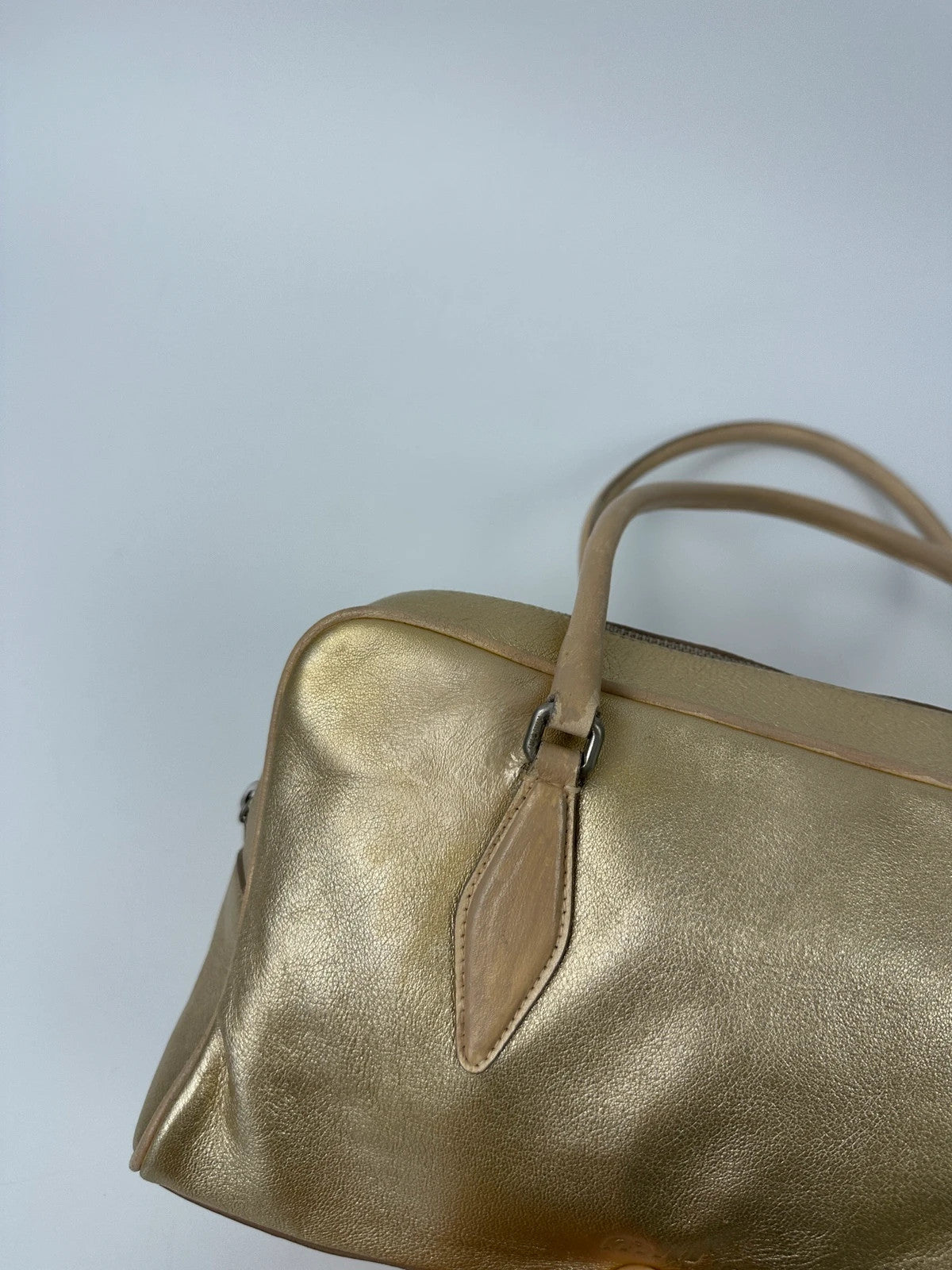 Miu Miu gold leather handbag with shiny finish and vintage 90’s design.