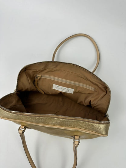 Miu Miu gold leather handbag with shiny finish and vintage 90’s design.