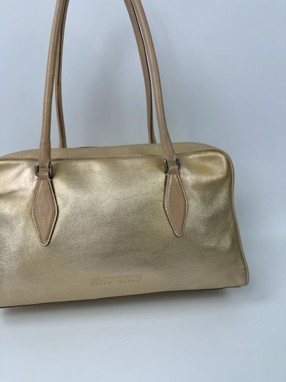 Miu Miu gold leather handbag with shiny finish and vintage 90’s design.