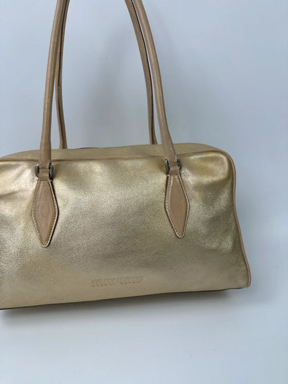 Miu Miu gold leather handbag with shiny finish and vintage 90’s design.