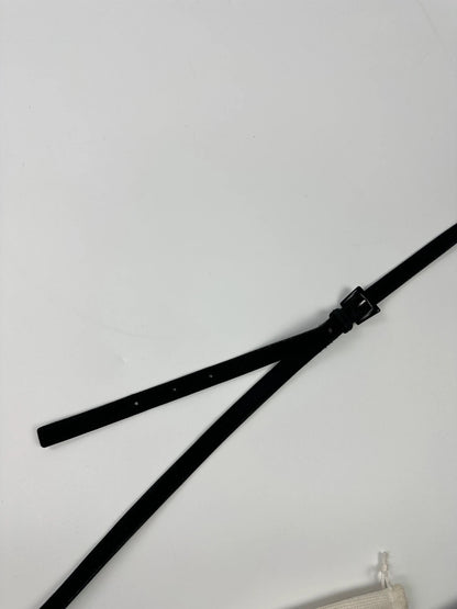 Prada black leather crossbody bag with fur accents and embossed logo.