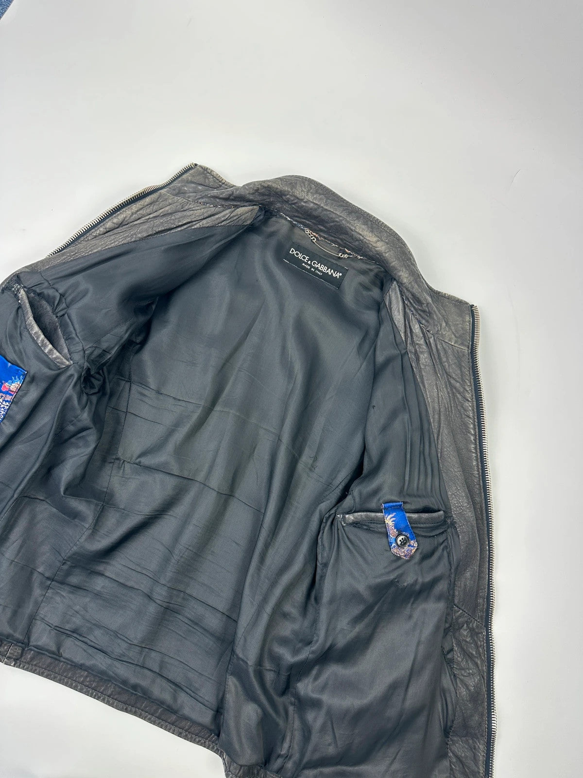 Dolce & Gabbana grey bomber jacket with unique eroded leather finish and faded details.