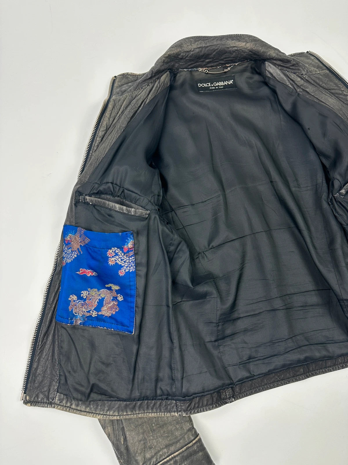 Dolce & Gabbana grey bomber jacket with unique eroded leather finish and faded details.