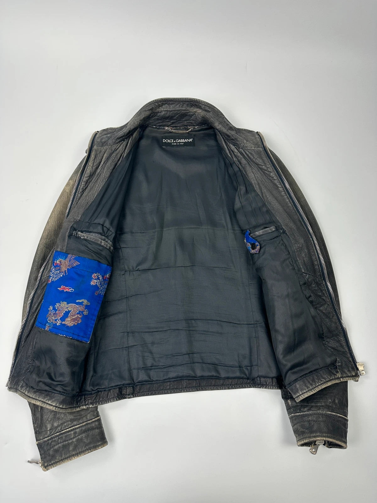 Dolce & Gabbana grey bomber jacket with unique eroded leather finish and faded details.