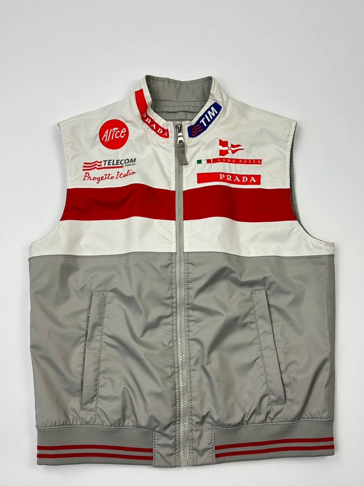 Prada red racing vest with white Luna Rossa logo and minimalist design.