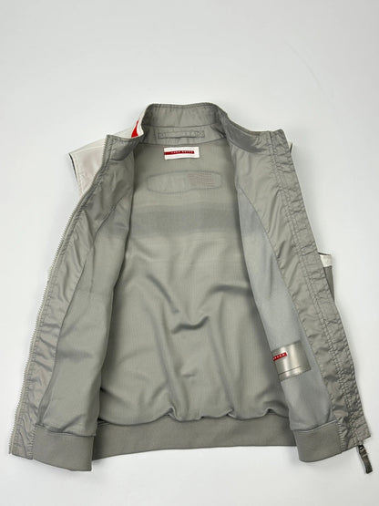 Prada red racing vest with white Luna Rossa logo and minimalist design.