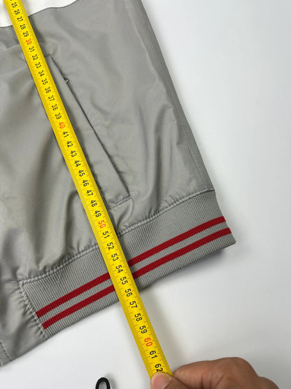 Prada red racing vest with white Luna Rossa logo and minimalist design.