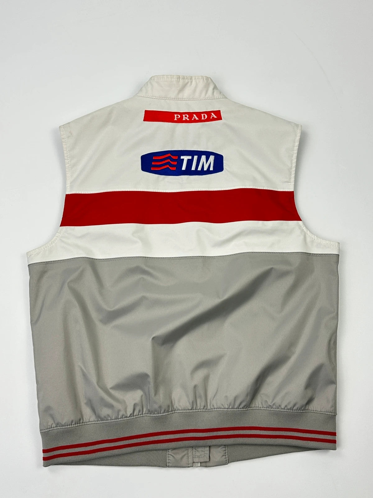 Prada red racing vest with white Luna Rossa logo and minimalist design.