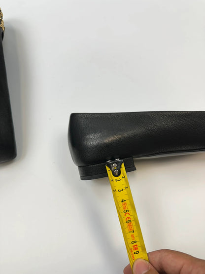 Prada black grained leather loafers with gold eyelets and triangle logo.