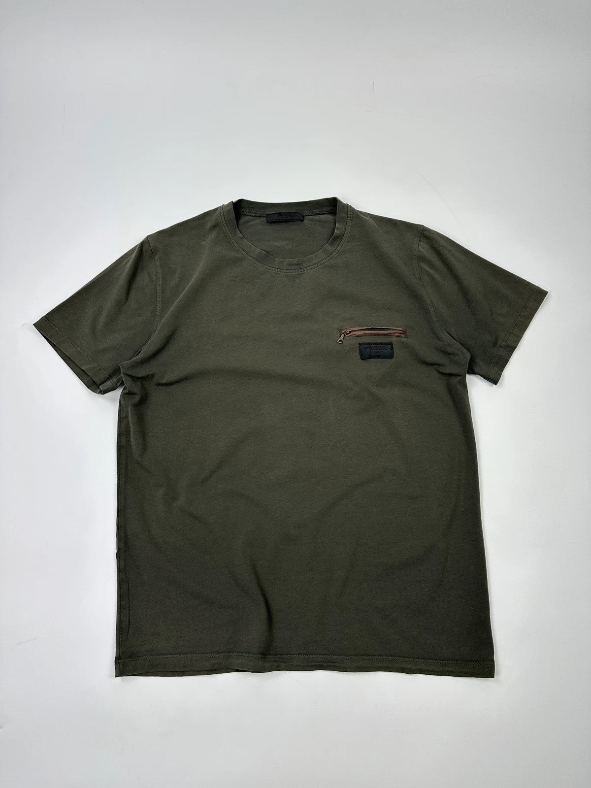 Prada khaki graphic t-shirt featuring zip chest pocket and minimalist design.