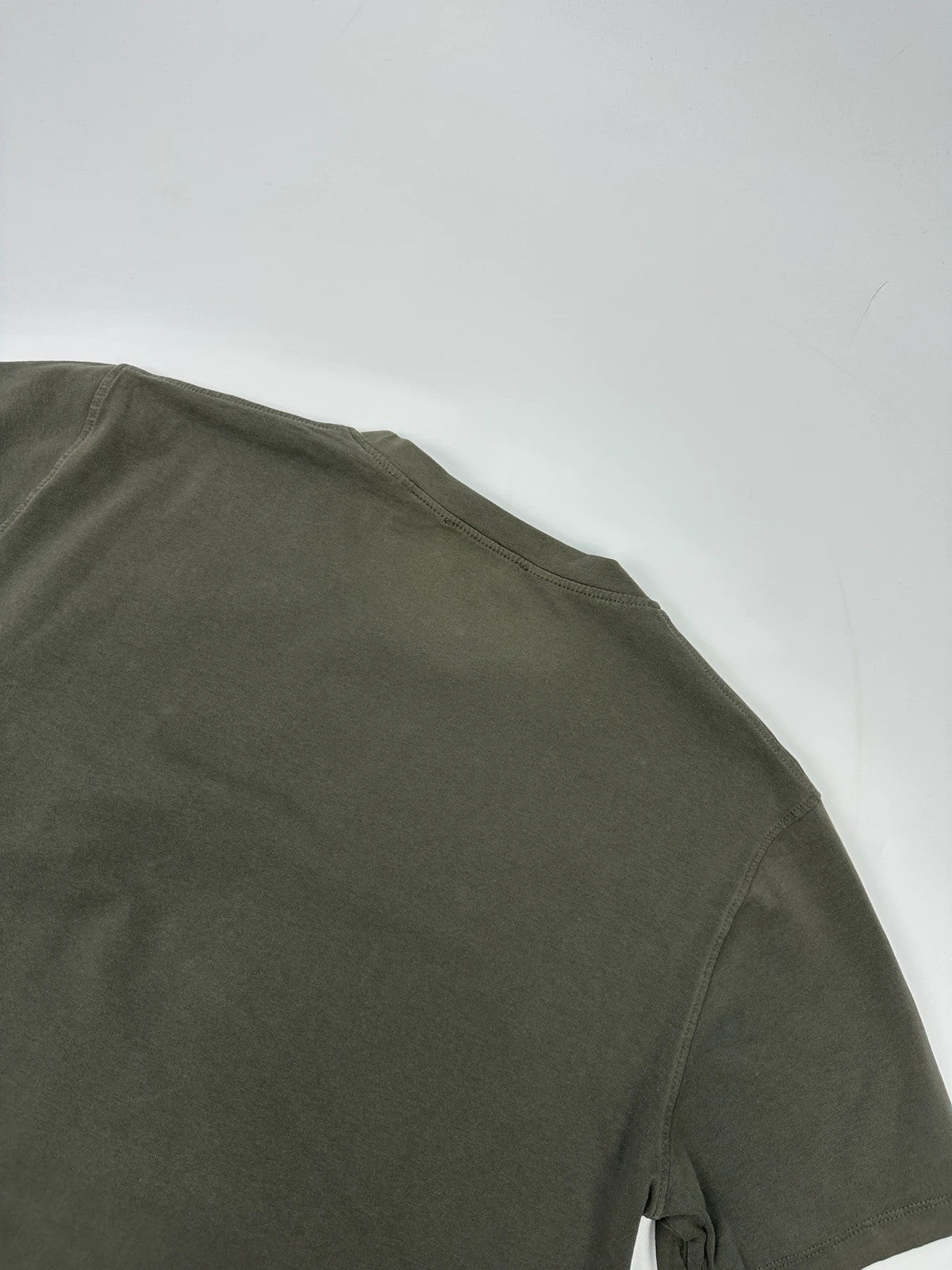Prada khaki graphic t-shirt featuring zip chest pocket and minimalist design.