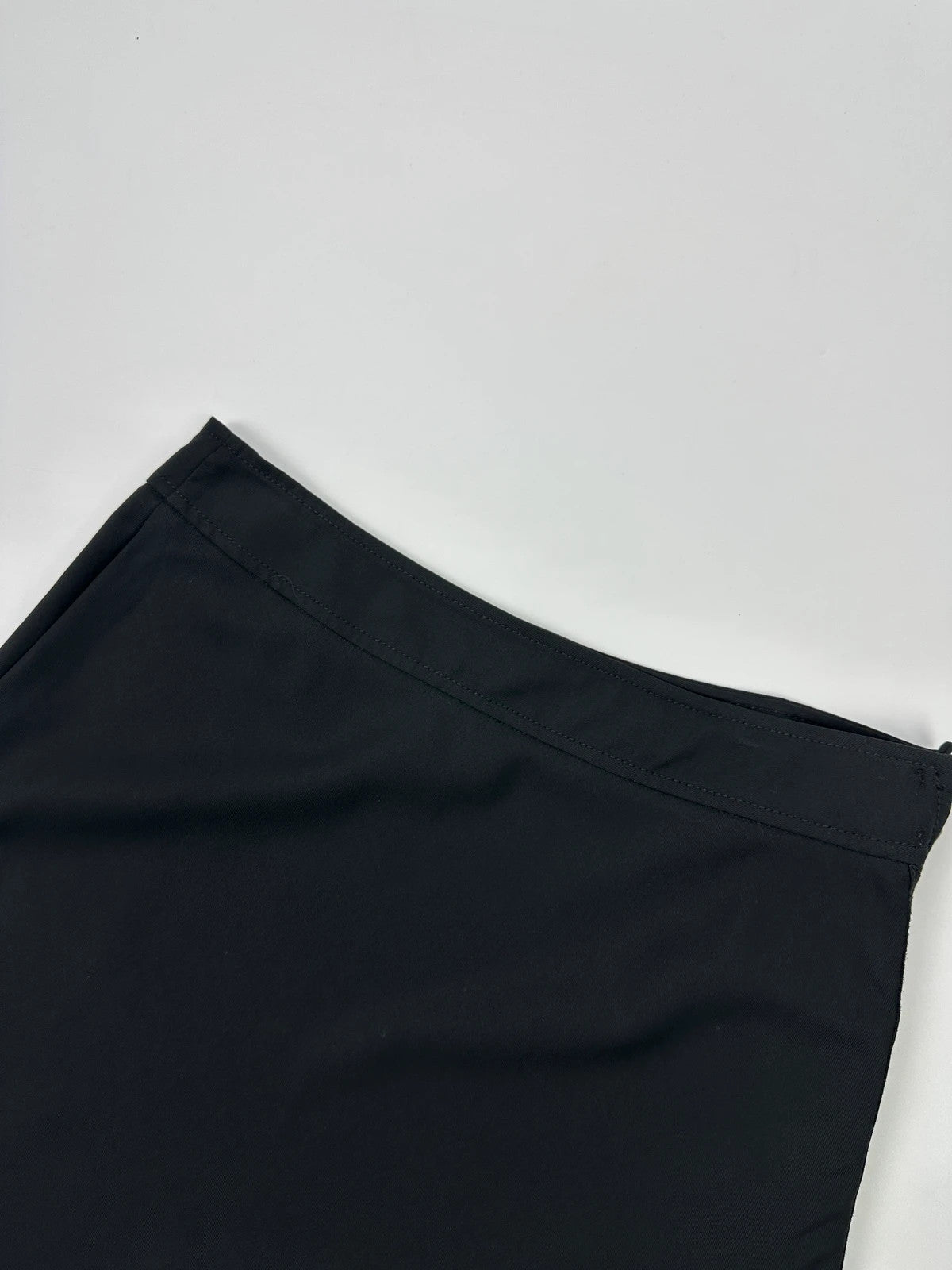 Prada black wool mid-length skirt with minimalist design and linearossa logo.