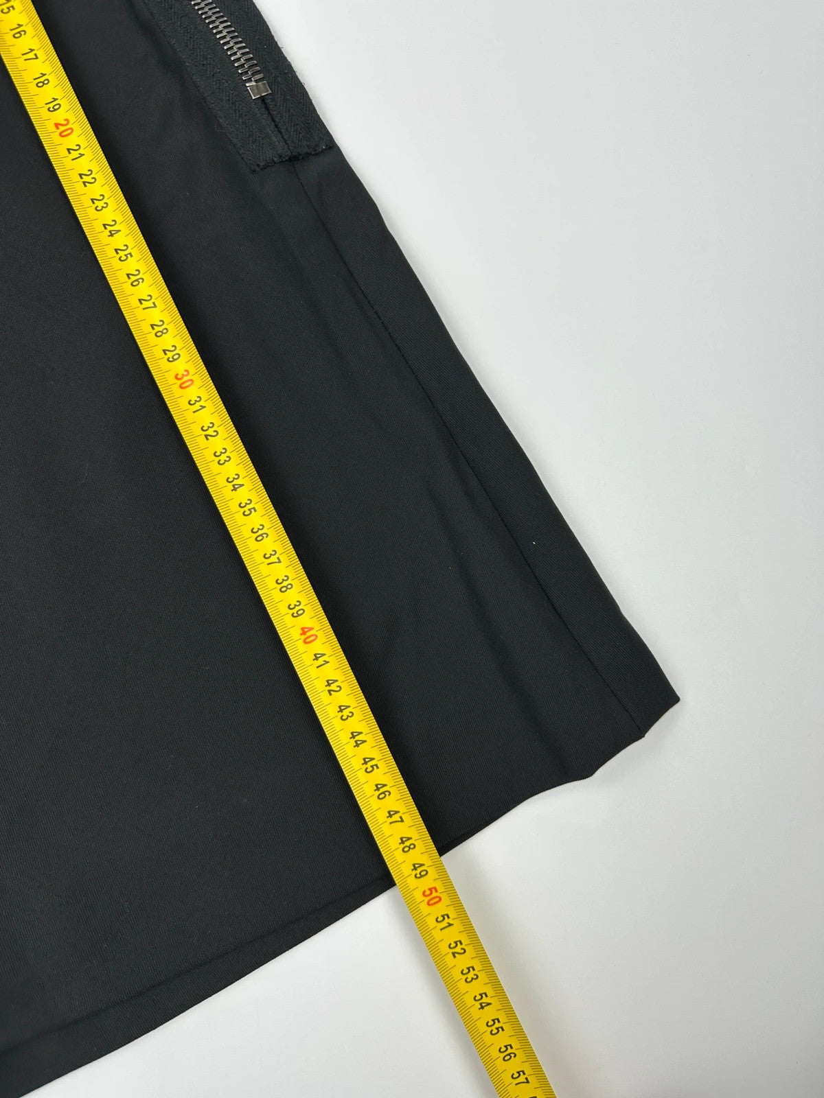 Prada black wool mid-length skirt with minimalist design and linearossa logo.