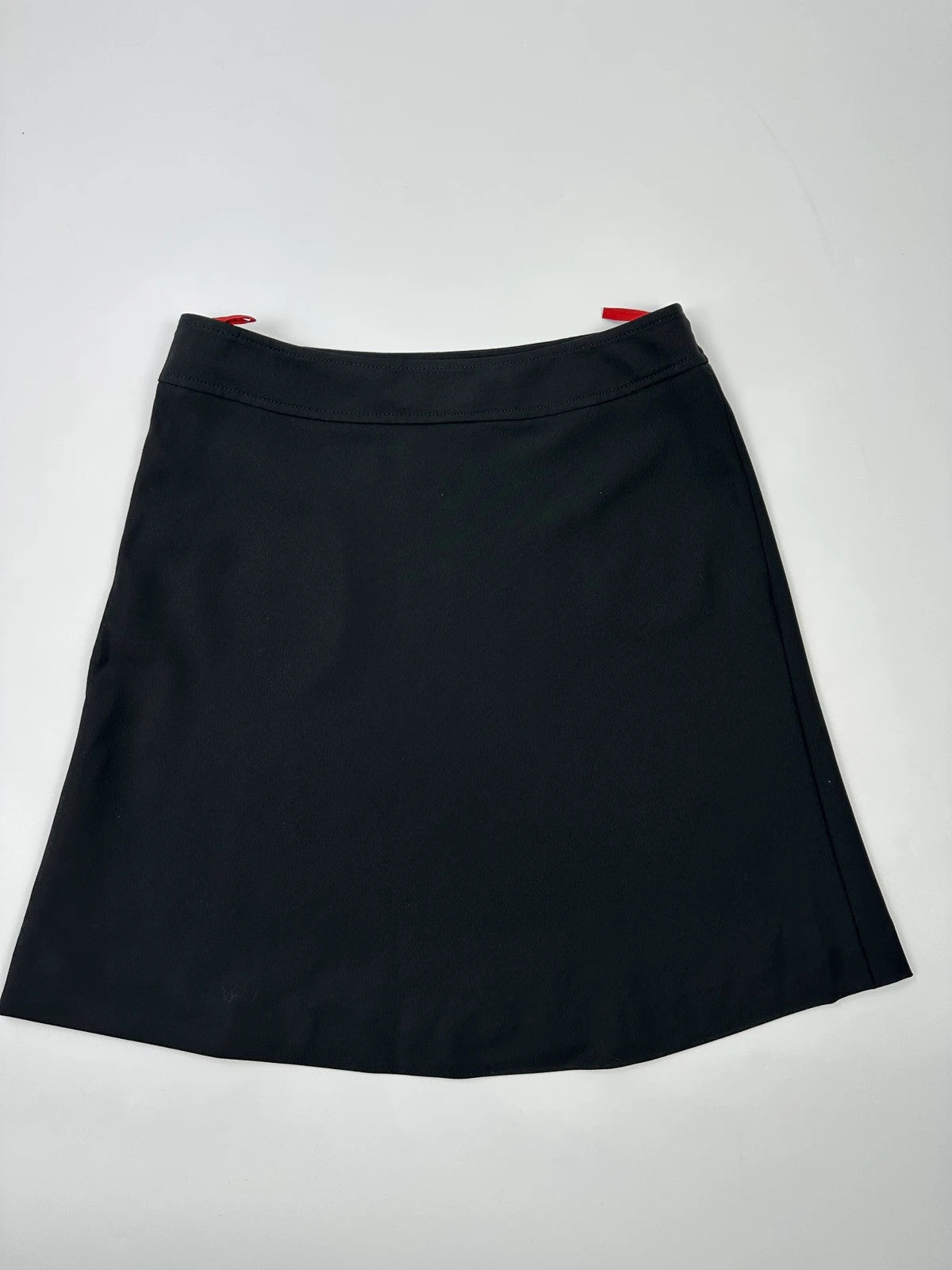 Prada black wool mid-length skirt with minimalist design and linearossa logo.