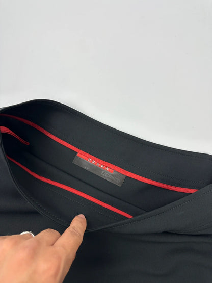 Prada black wool mid-length skirt with minimalist design and linearossa logo.