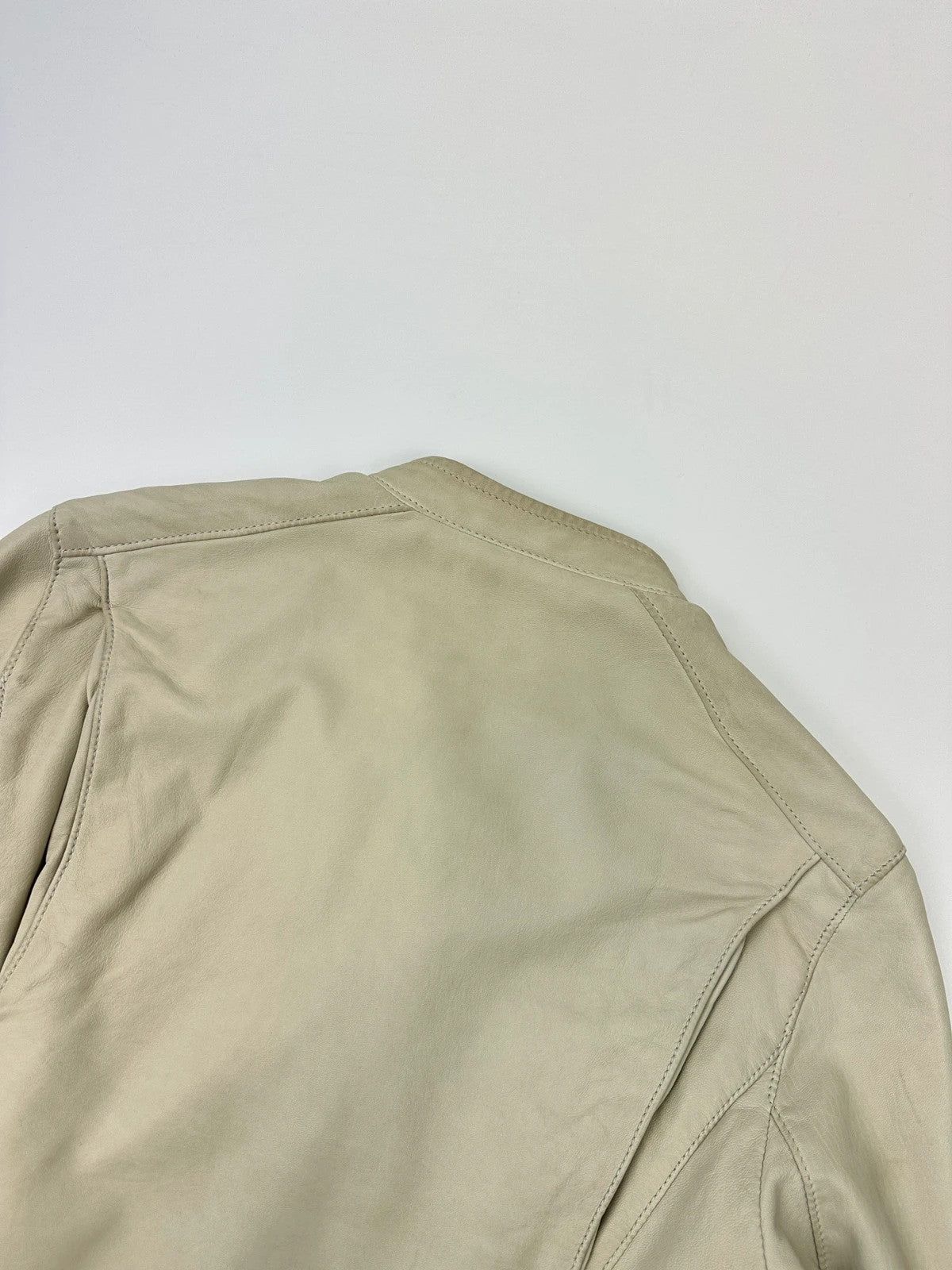Prada beige leather fitted jacket with multi pockets and logo detailing.