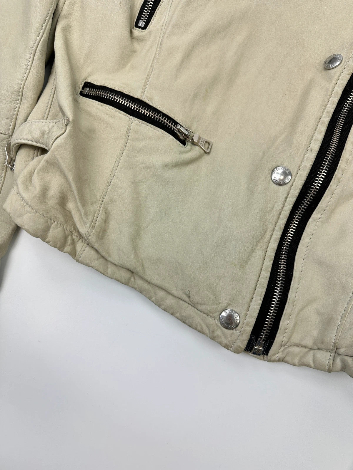 Prada beige leather fitted jacket with multi pockets and logo detailing.