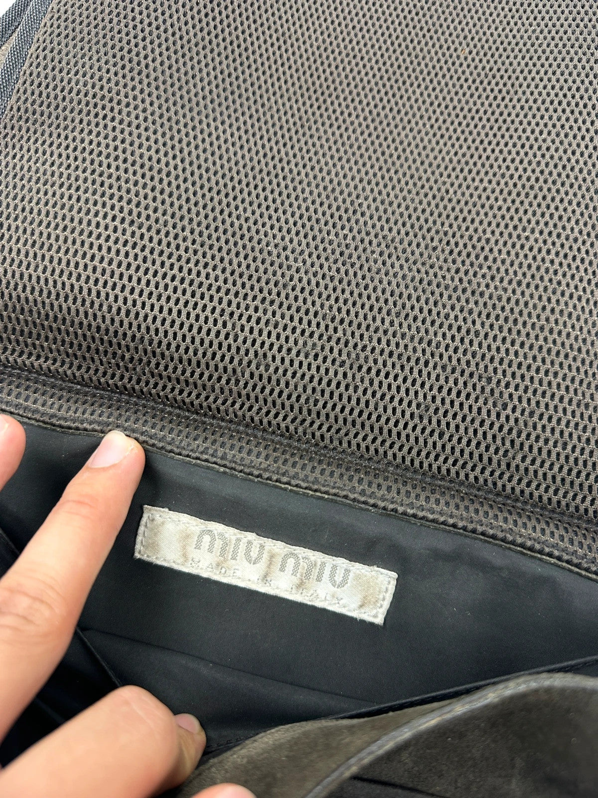 Miu Miu brown suede and mesh crossbody bag with logo detail and vintage design.