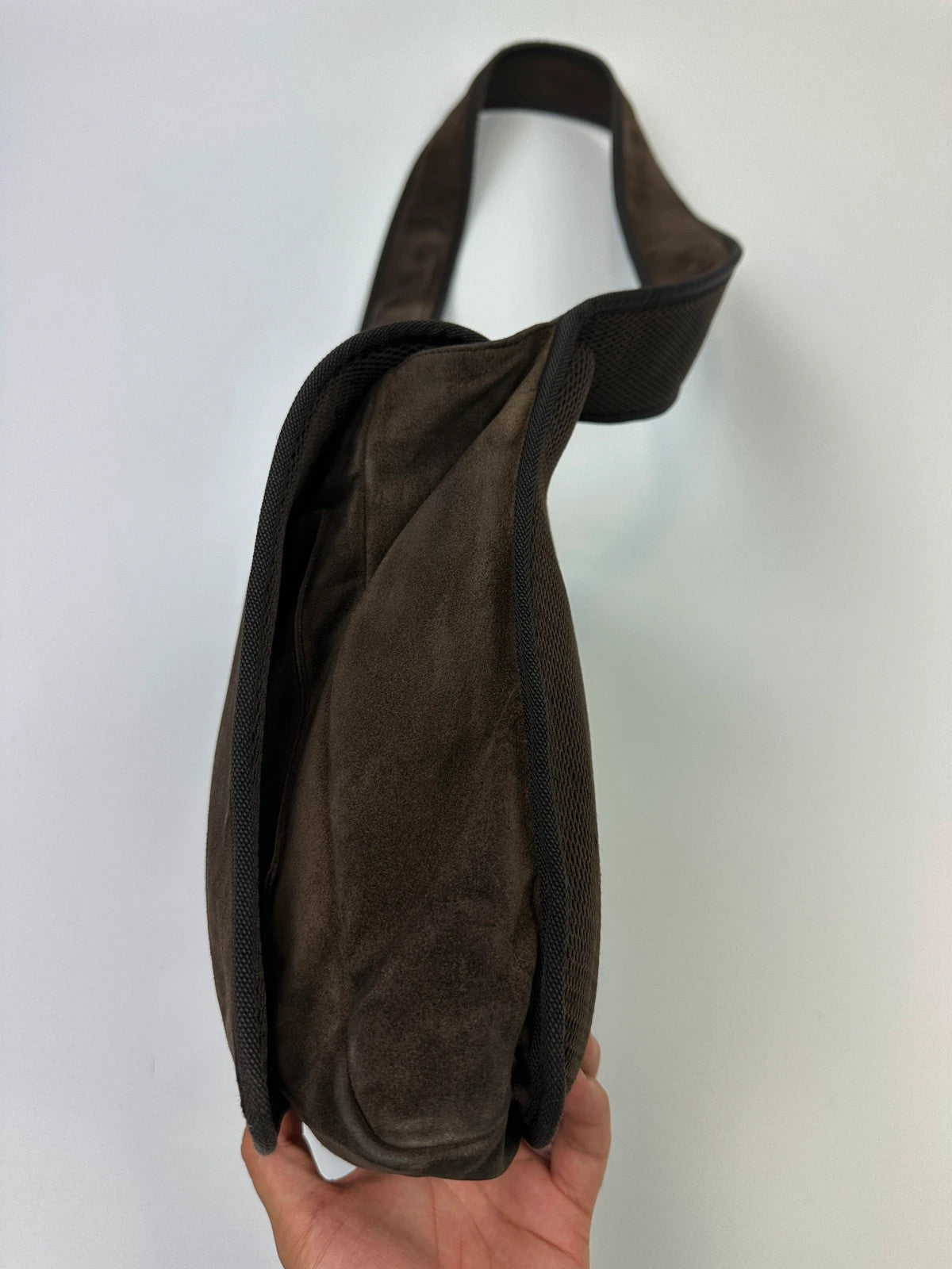Miu Miu brown suede and mesh crossbody bag with logo detail and vintage design.