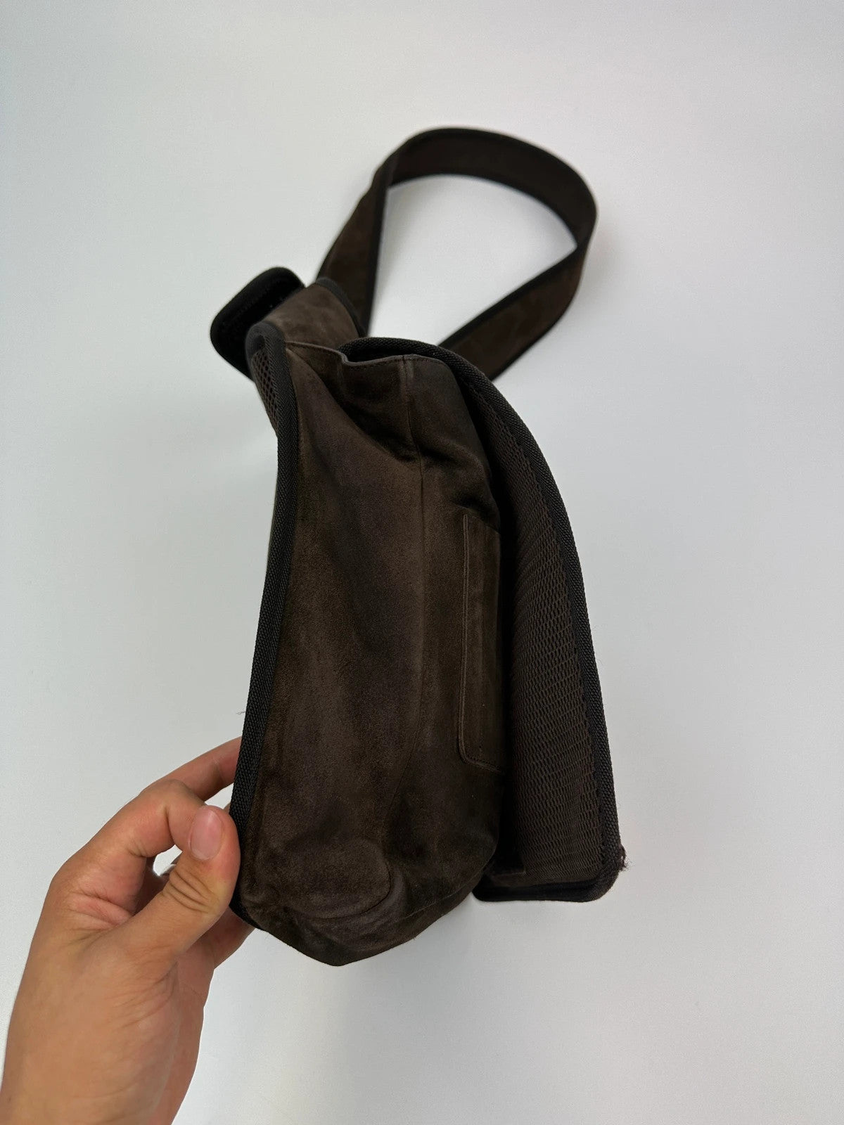 Miu Miu brown suede and mesh crossbody bag with logo detail and vintage design.