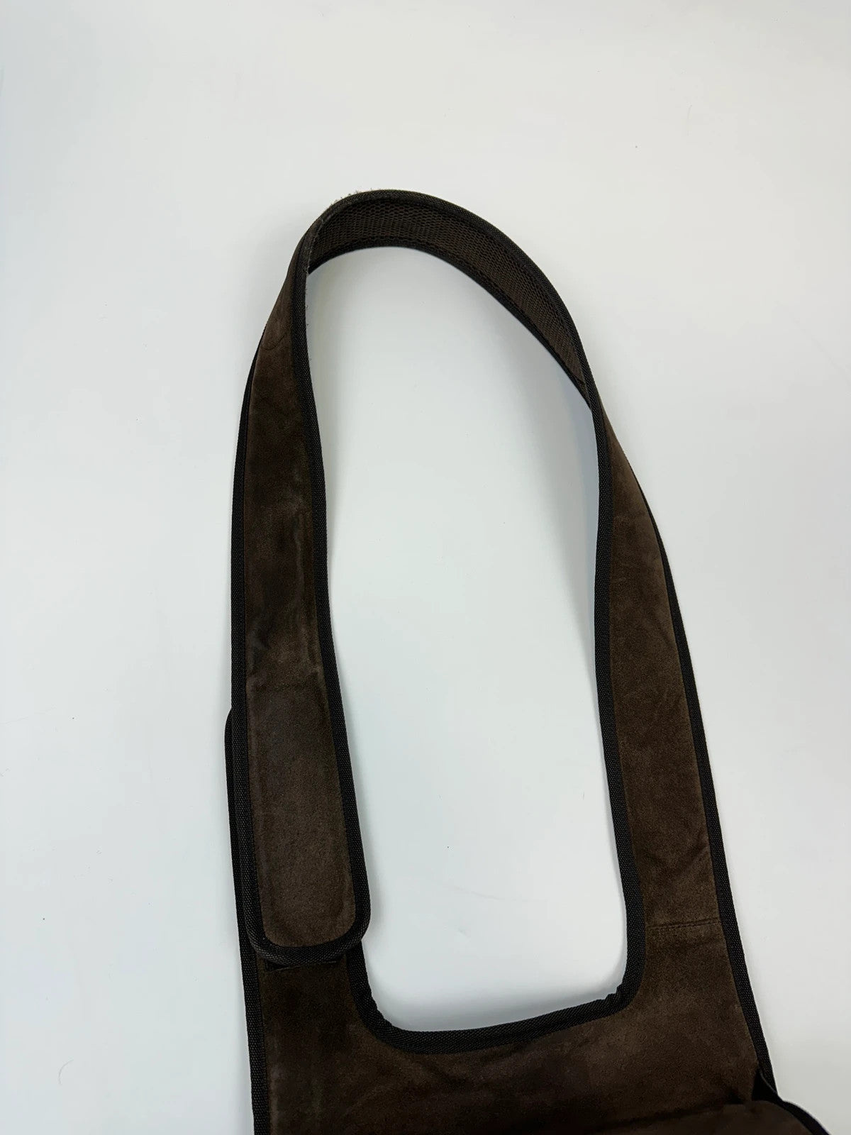 Miu Miu brown suede and mesh crossbody bag with logo detail and vintage design.
