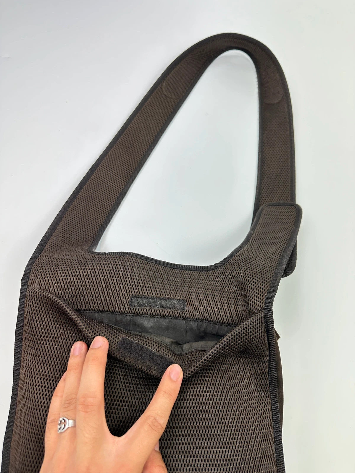 Miu Miu brown suede and mesh crossbody bag with logo detail and vintage design.