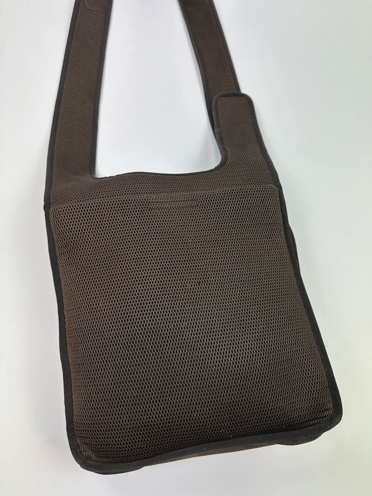 Miu Miu brown suede and mesh crossbody bag with logo detail and vintage design.