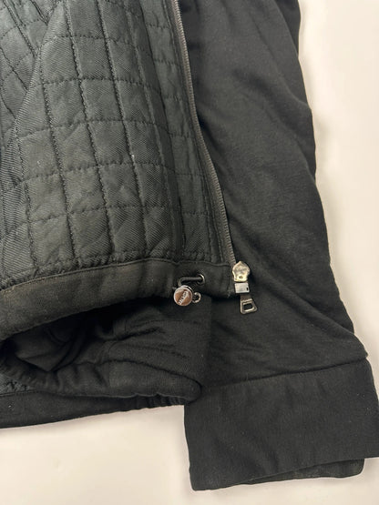 Prada black padded hooded jacket with 90s-inspired patch and braided drawstrings.