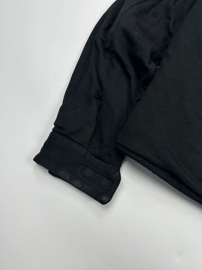 Prada black padded hooded jacket with 90s-inspired patch and braided drawstrings.