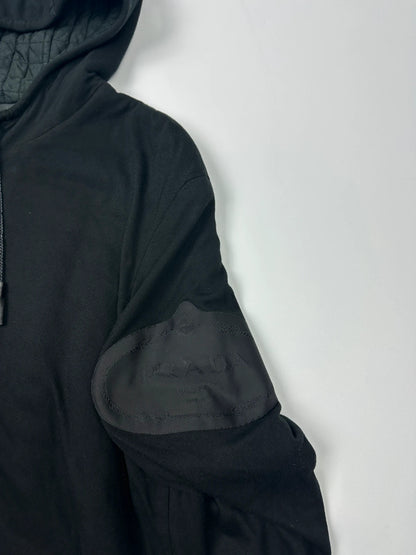 Prada black padded hooded jacket with 90s-inspired patch and braided drawstrings.