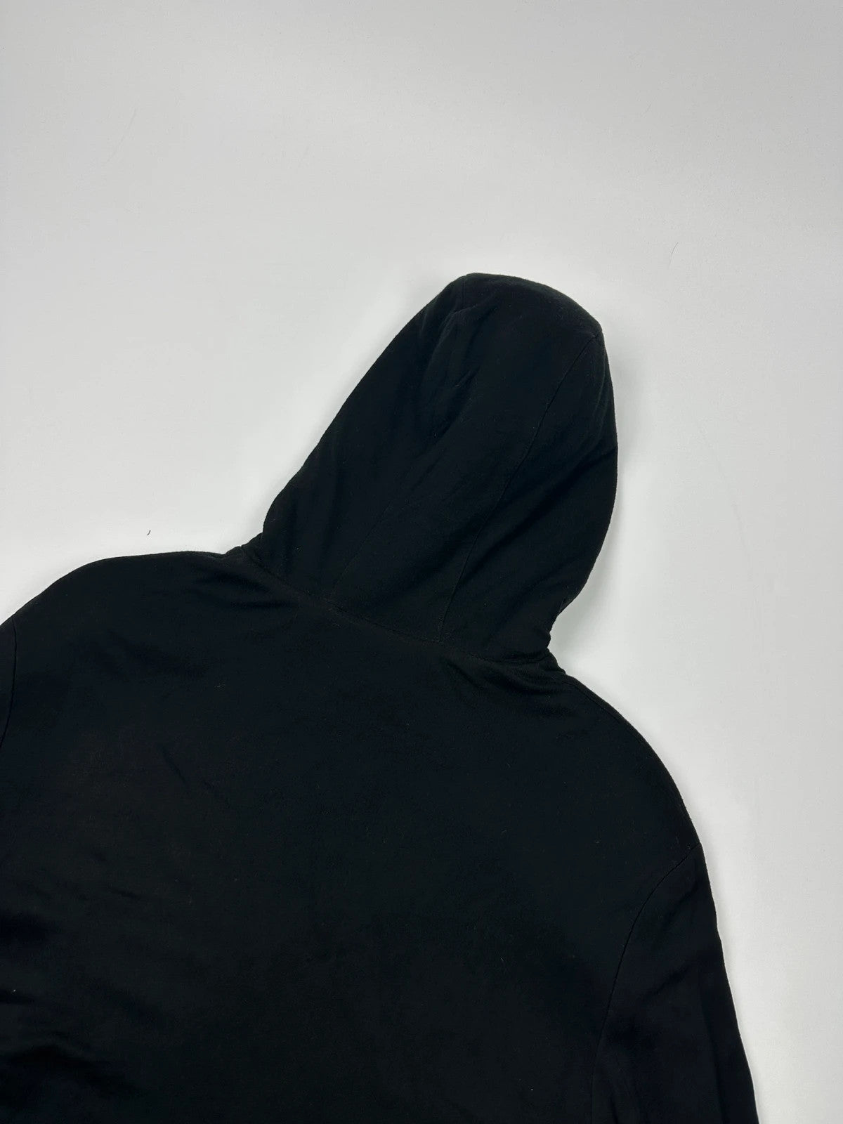 Prada black padded hooded jacket with 90s-inspired patch and braided drawstrings.