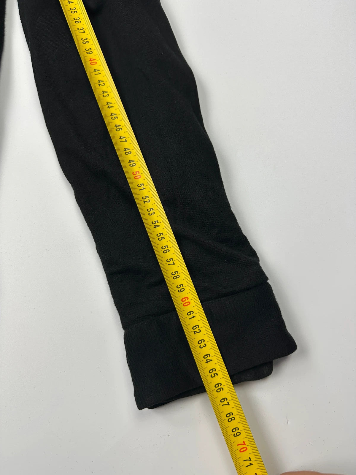Prada black padded hooded jacket with 90s-inspired patch and braided drawstrings.