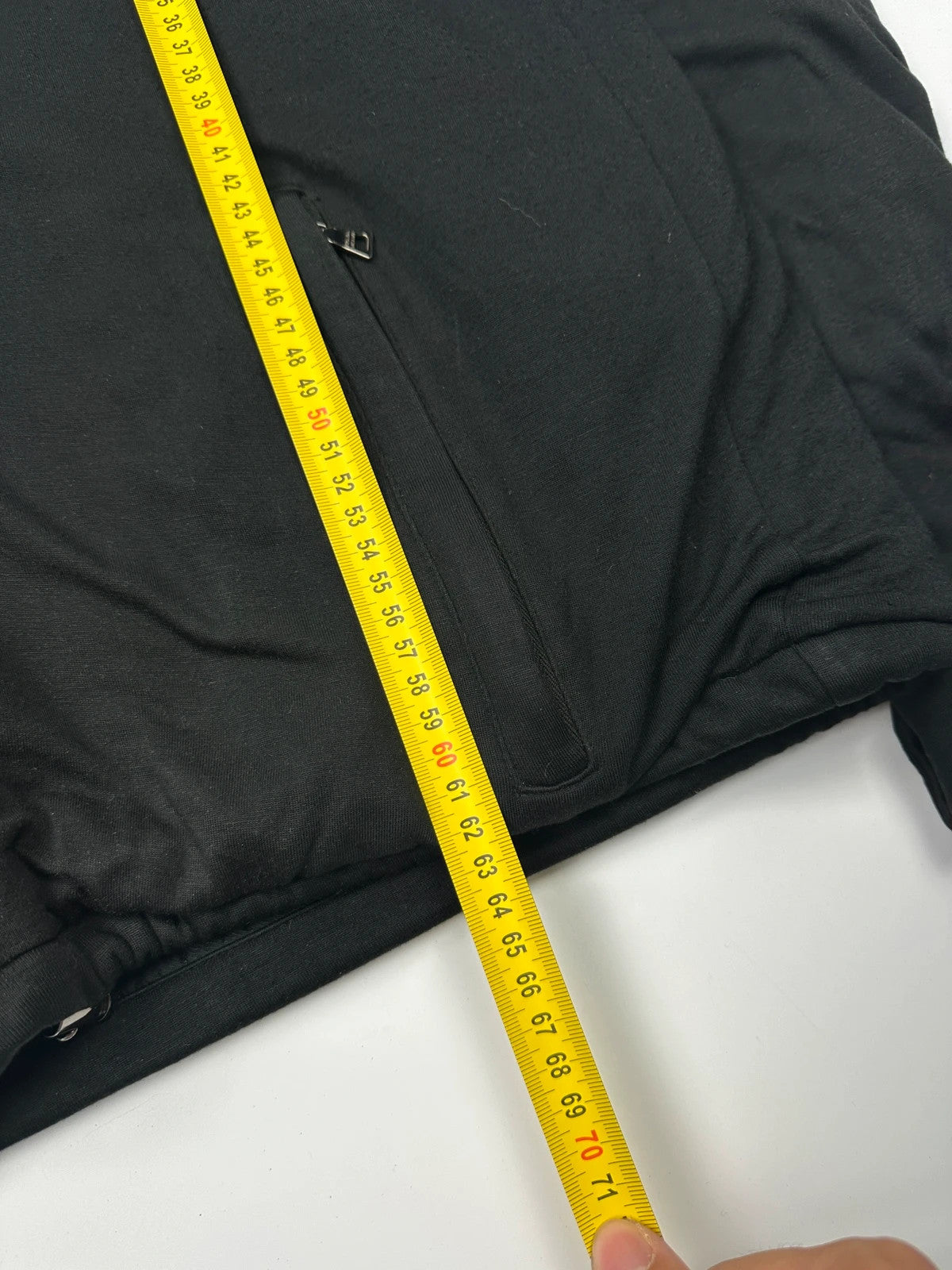 Prada black padded hooded jacket with 90s-inspired patch and braided drawstrings.