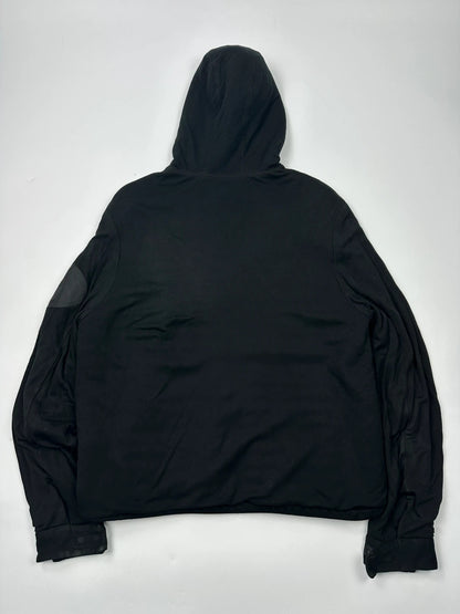 Prada black padded hooded jacket with 90s-inspired patch and braided drawstrings.
