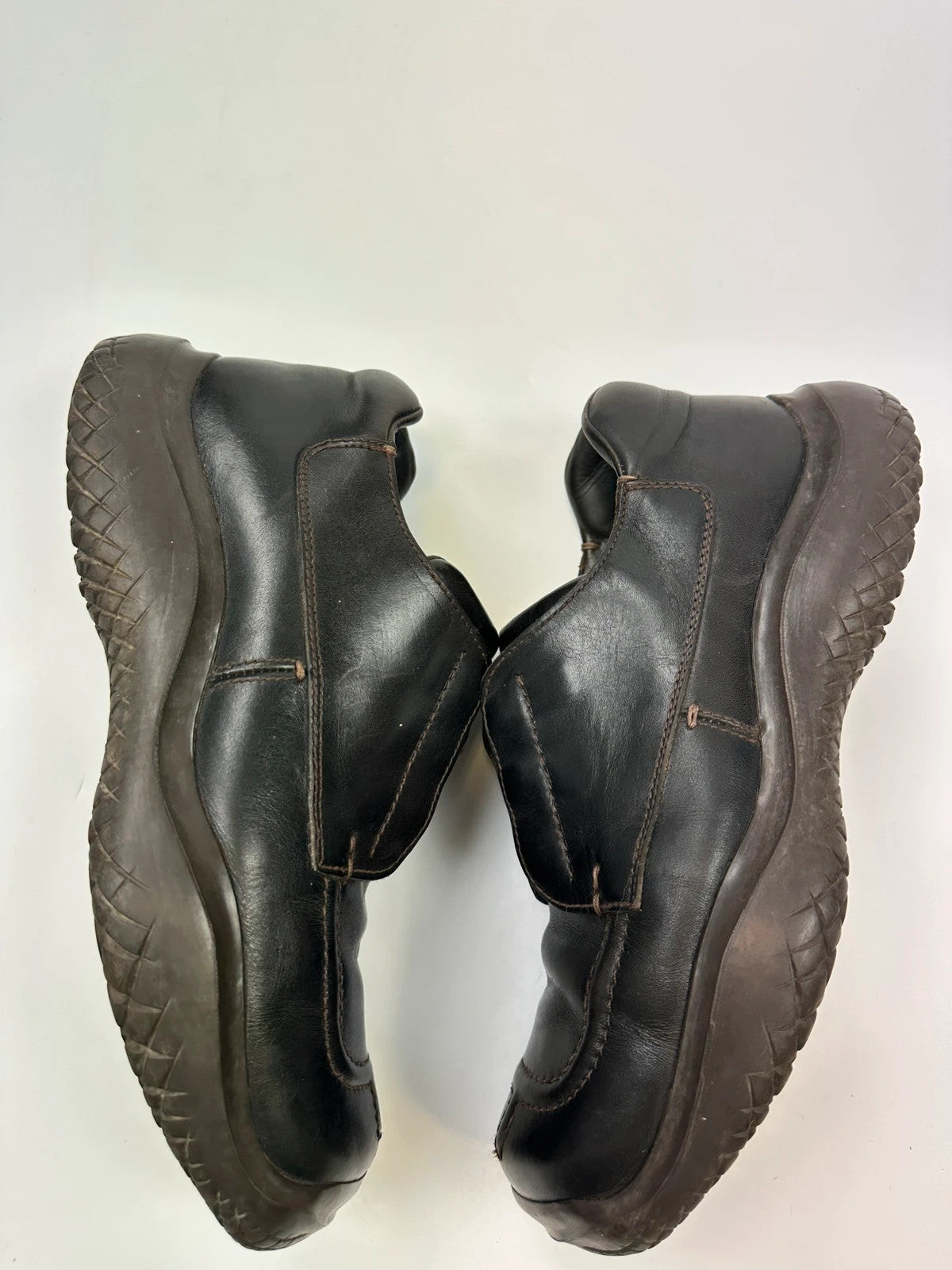 Prada black leather Derby shoes with Vibram sole and Linearossa logo detail.