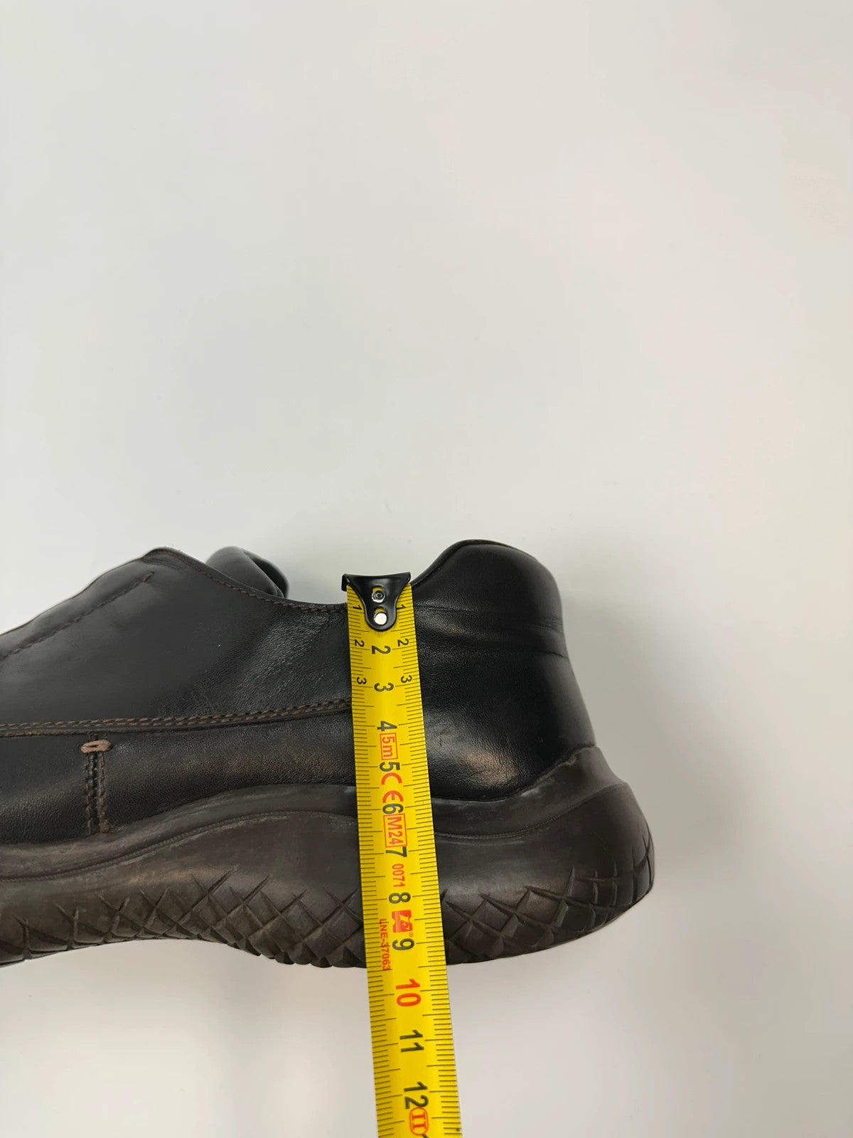 Prada black leather Derby shoes with Vibram sole and Linearossa logo detail.