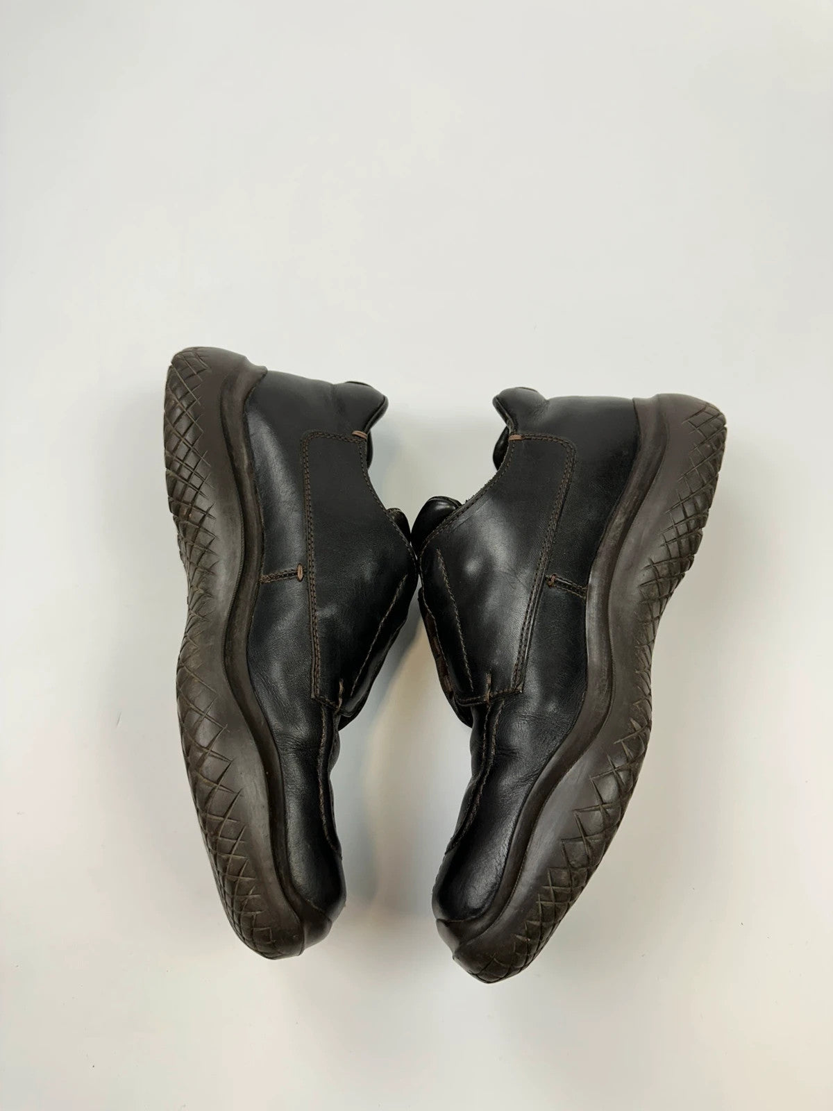 Prada black leather Derby shoes with Vibram sole and Linearossa logo detail.