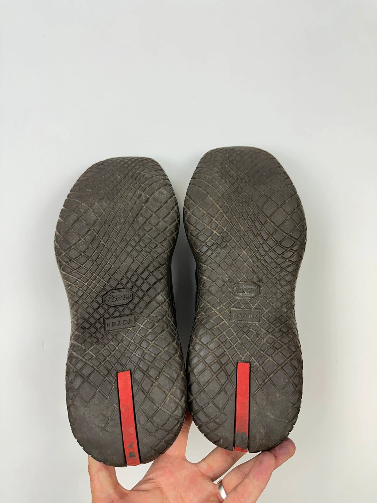Prada black leather Derby shoes with Vibram sole and Linearossa logo detail.
