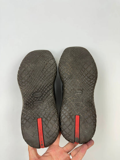 Prada black leather Derby shoes with Vibram sole and Linearossa logo detail.