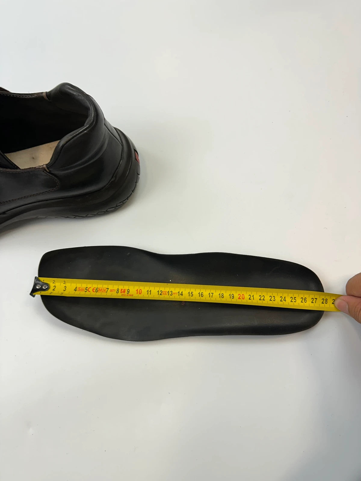 Prada black leather Derby shoes with Vibram sole and Linearossa logo detail.
