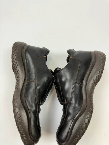 Prada black leather Derby shoes with Vibram sole and Linearossa logo detail.
