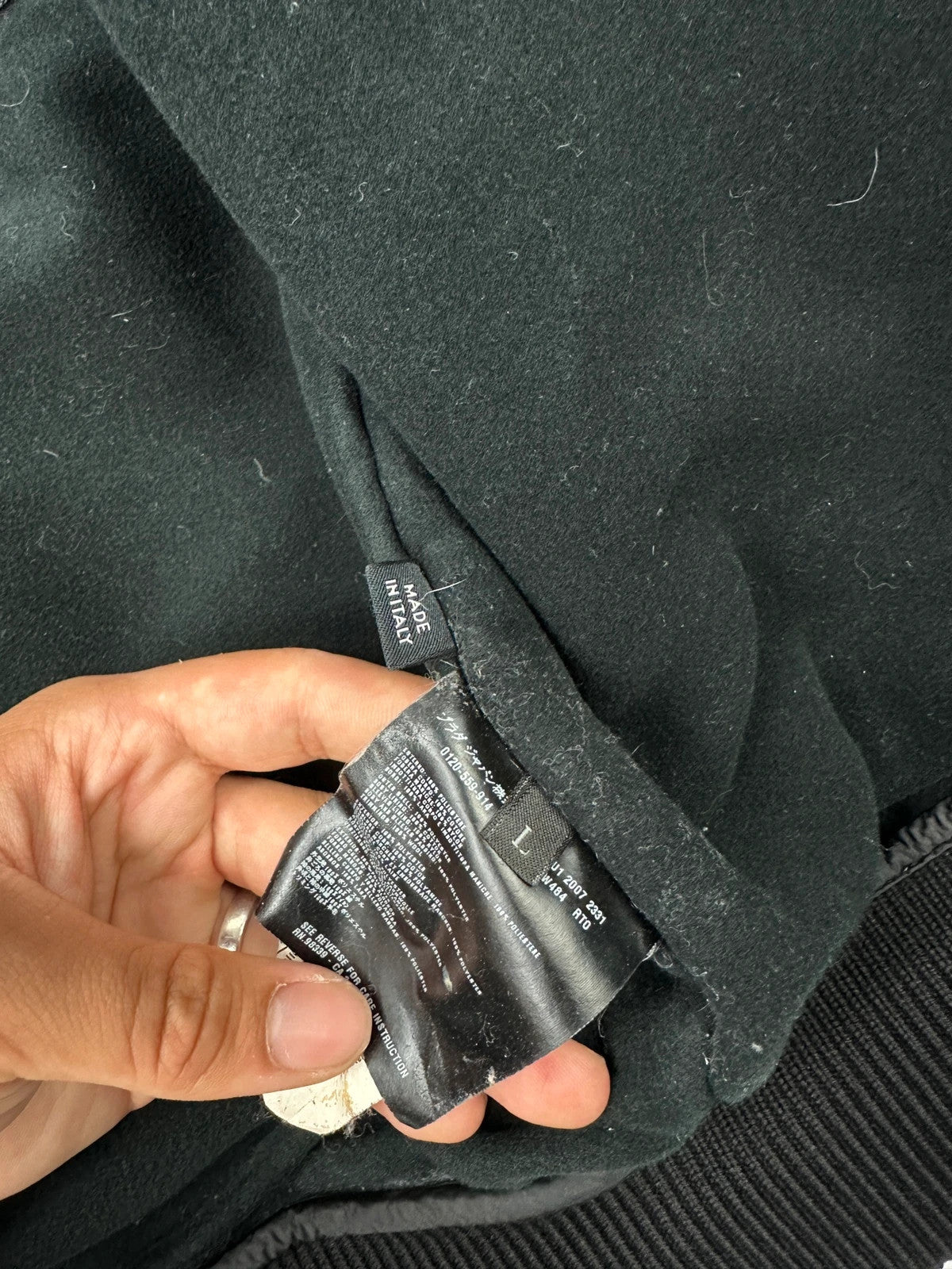 Prada black bomber jacket with hidden hood, minimalist design, luxury runway archive.