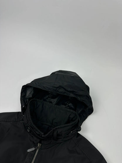 Prada black bomber jacket with hidden hood, minimalist design, luxury runway archive.