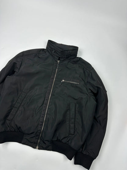 Prada black bomber jacket with hidden hood, minimalist design, luxury runway archive.
