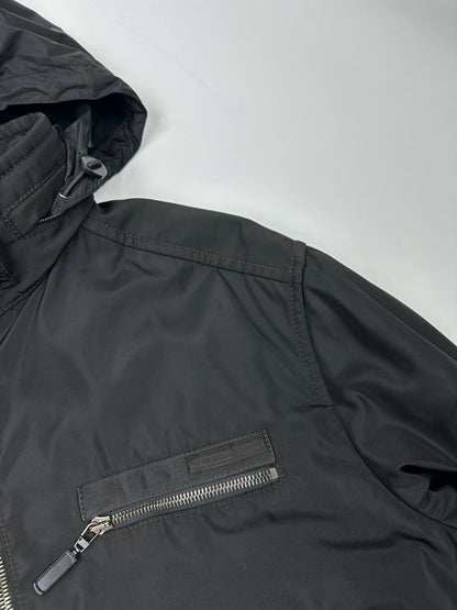 Prada black bomber jacket with hidden hood, minimalist design, luxury runway archive.