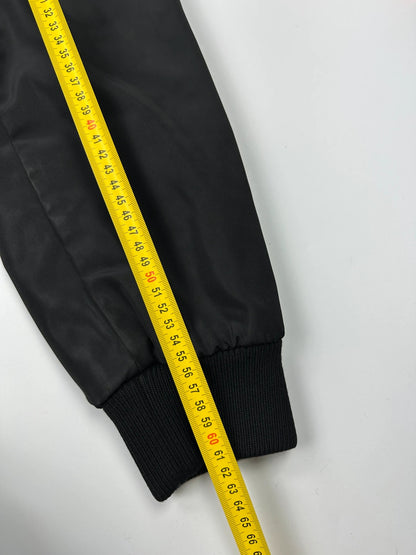 Prada black bomber jacket with hidden hood, minimalist design, luxury runway archive.