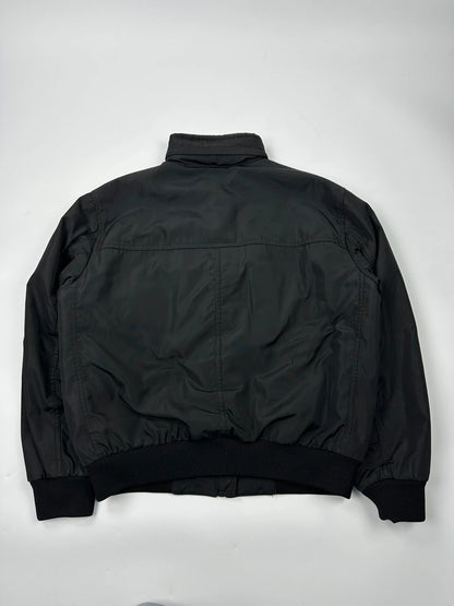 Prada black bomber jacket with hidden hood, minimalist design, luxury runway archive.